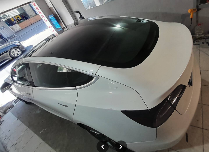 White Tesla Model 3 with tinted roof and rear glass